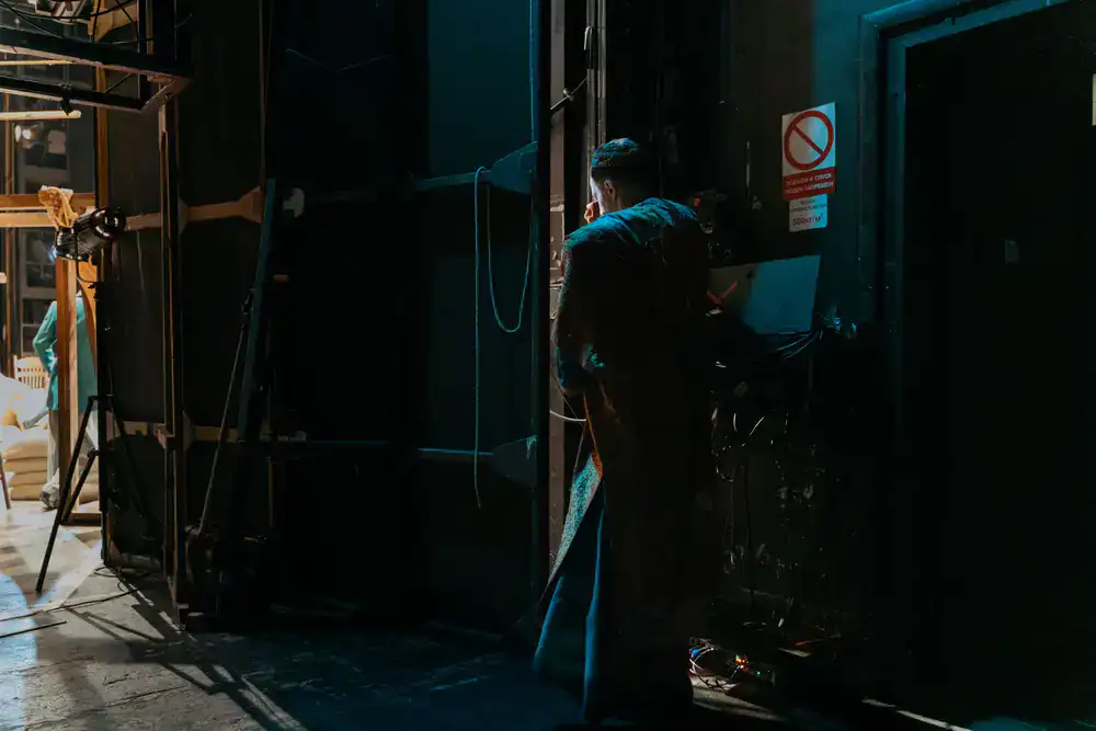 Cast standing in dim light