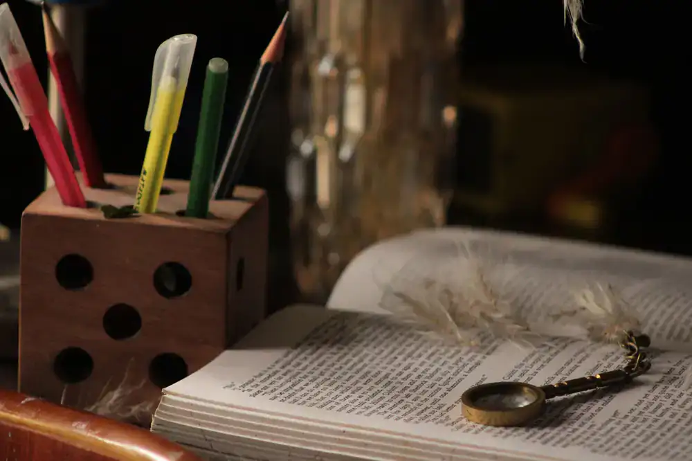 Dusty books and a magnifying glass on a desk